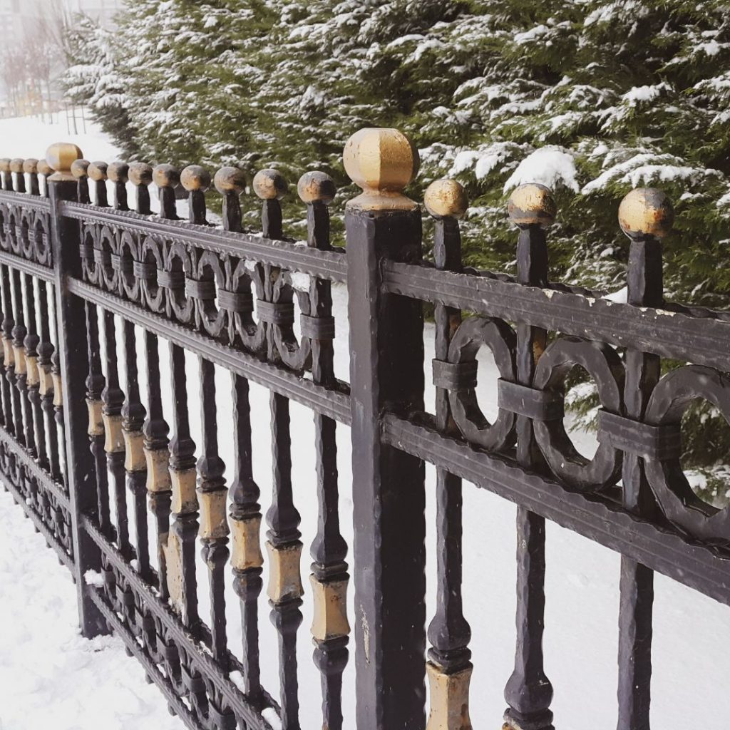 What Are The Main Advantages Of Installing An Iron Fence On My Property iron fence in snow
